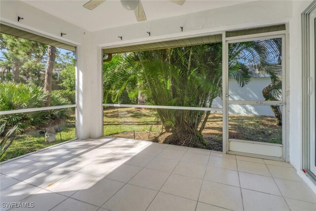 unfurnished sunroom featuring ceiling fan