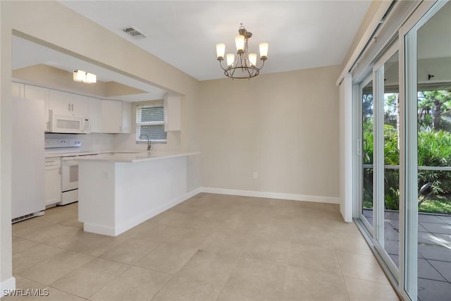 kitchen featuring decorative light fixtures, white cabinetry, a notable chandelier, kitchen peninsula, and white appliances