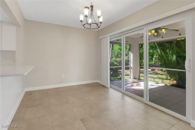 unfurnished dining area featuring ceiling fan with notable chandelier and light tile patterned floors