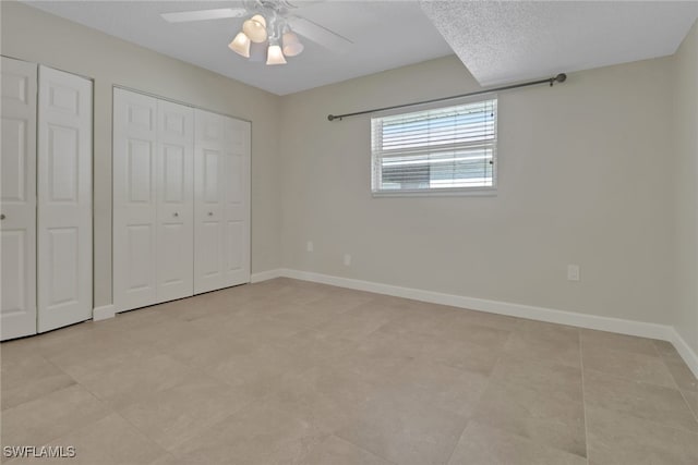 unfurnished bedroom featuring a textured ceiling and ceiling fan