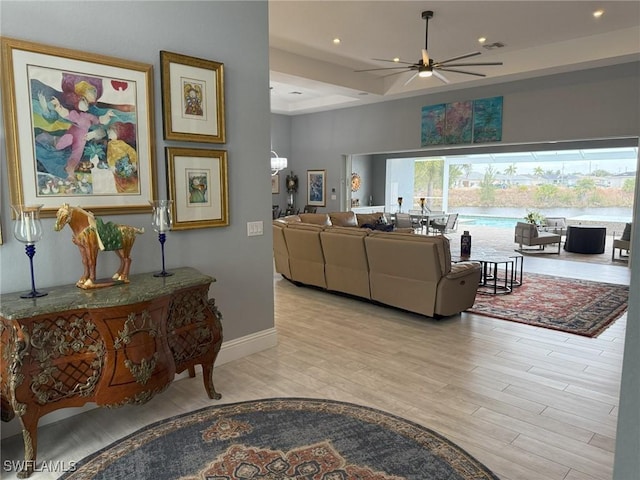 living room featuring ceiling fan and light hardwood / wood-style flooring