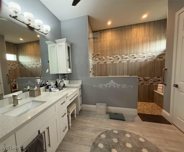 bathroom featuring vanity and tiled shower