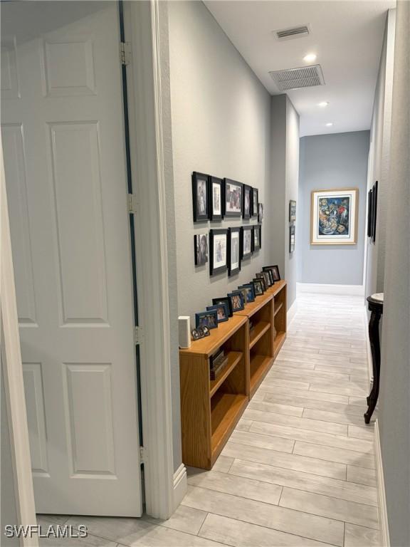 hallway with light hardwood / wood-style flooring