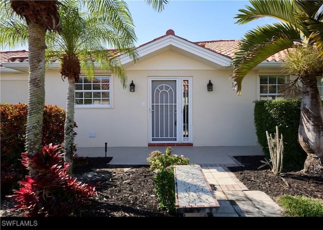 entrance to property with a patio