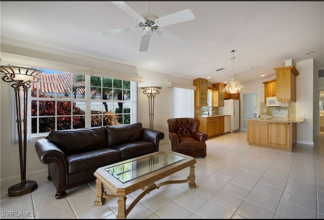 living room with light tile patterned floors, sink, and ceiling fan