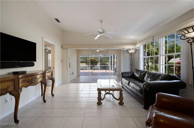 living room with light tile patterned flooring, vaulted ceiling, and ceiling fan