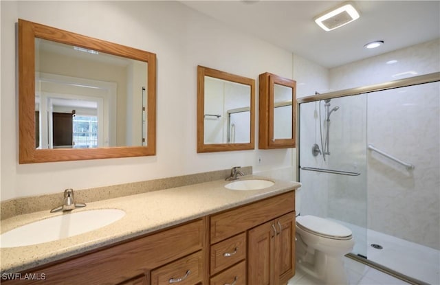 bathroom featuring vanity, toilet, and walk in shower