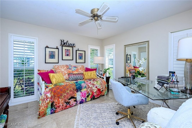 bedroom with ceiling fan and multiple windows