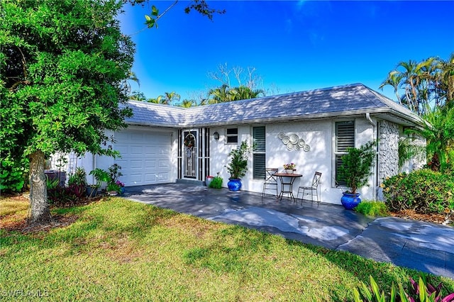 ranch-style home with a front yard and a garage