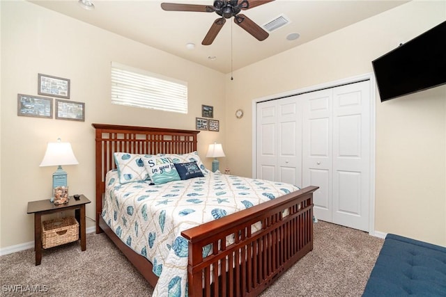 bedroom with light colored carpet, ceiling fan, and a closet