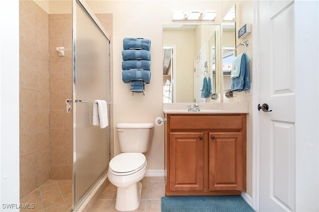 bathroom featuring vanity, a shower with shower door, tile patterned floors, and toilet