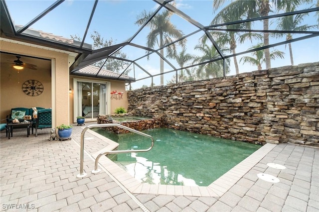 view of swimming pool featuring a lanai and a patio area