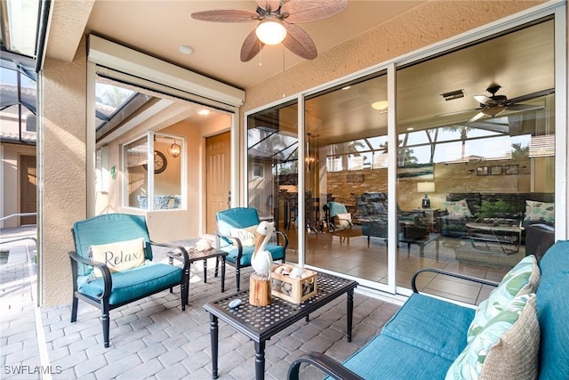 sunroom with ceiling fan