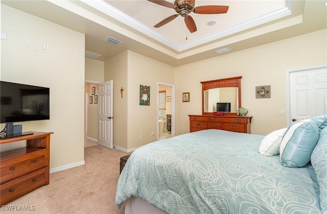 bedroom featuring ceiling fan, ornamental molding, a tray ceiling, and light carpet