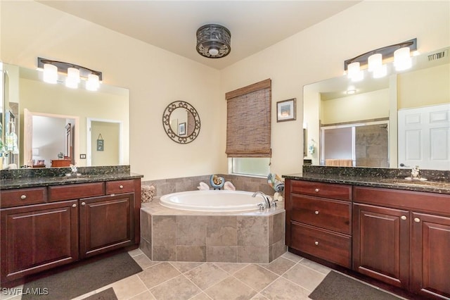 bathroom featuring tile patterned floors, plus walk in shower, and vanity