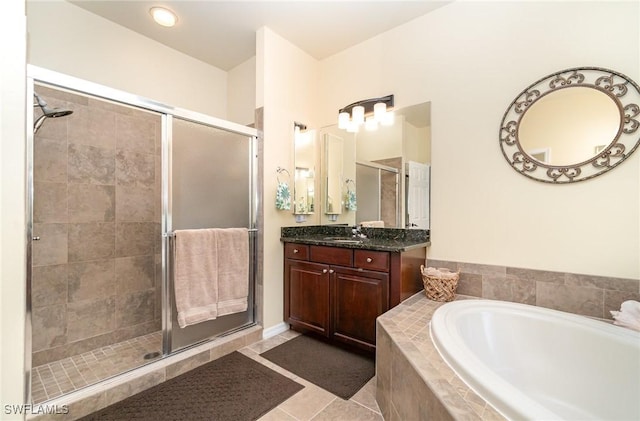 bathroom with tile patterned flooring, vanity, and shower with separate bathtub