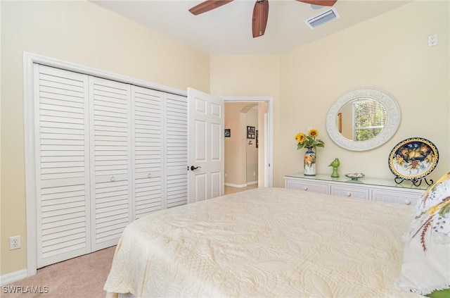 carpeted bedroom with ceiling fan and a closet