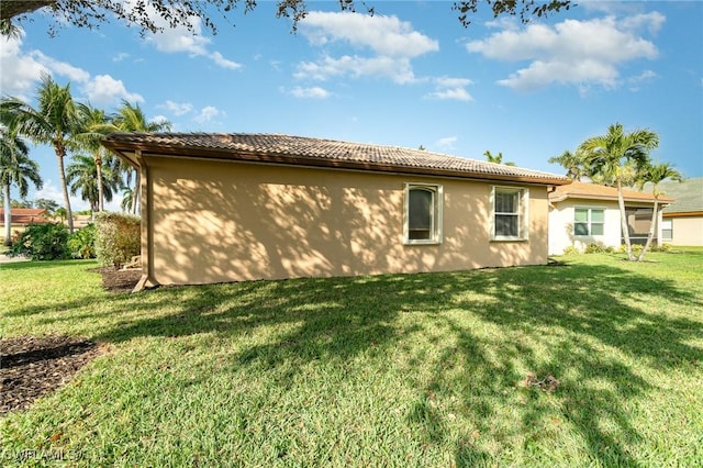 back of house with a lawn