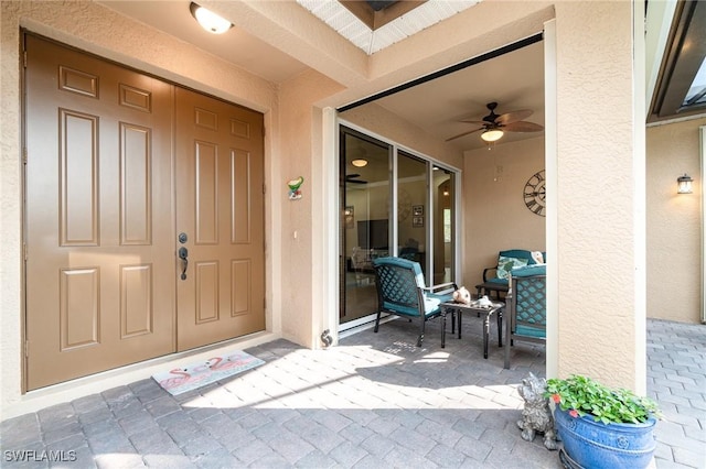 entrance to property with ceiling fan