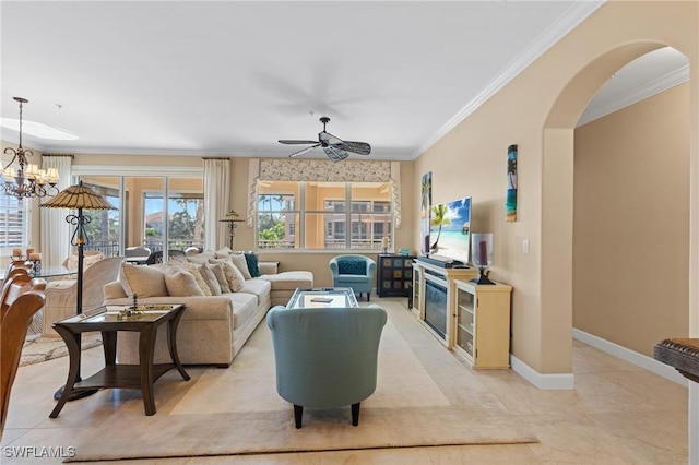 tiled living room with ceiling fan with notable chandelier and ornamental molding