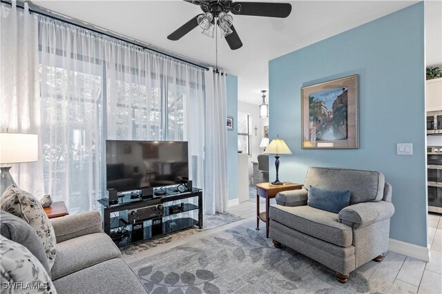 living room featuring plenty of natural light and ceiling fan