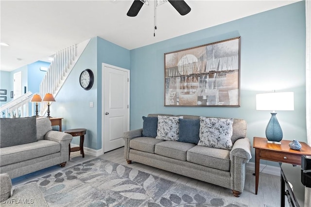 living room featuring ceiling fan and wood-type flooring