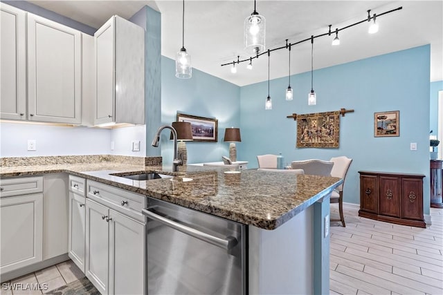 kitchen featuring kitchen peninsula, white cabinetry, and sink