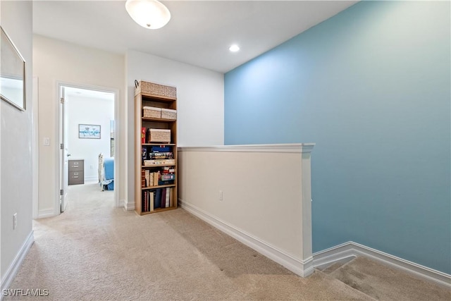 corridor featuring light colored carpet