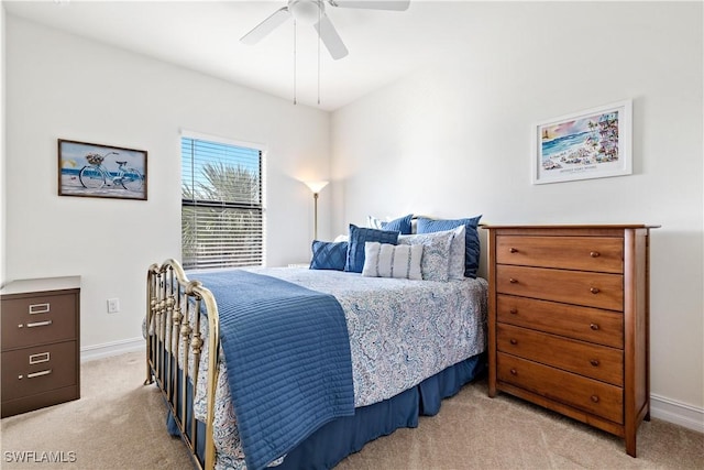 bedroom featuring light colored carpet and ceiling fan