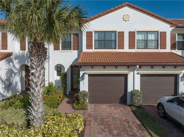 mediterranean / spanish home featuring a garage