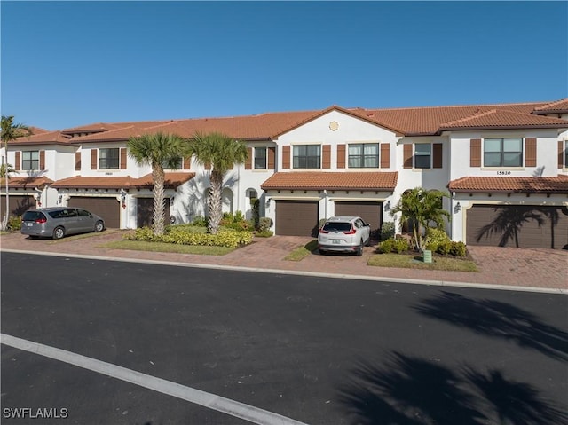 mediterranean / spanish home featuring a garage