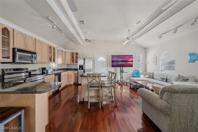 kitchen featuring a breakfast bar, dark wood-type flooring, stainless steel appliances, light brown cabinetry, and ornamental molding