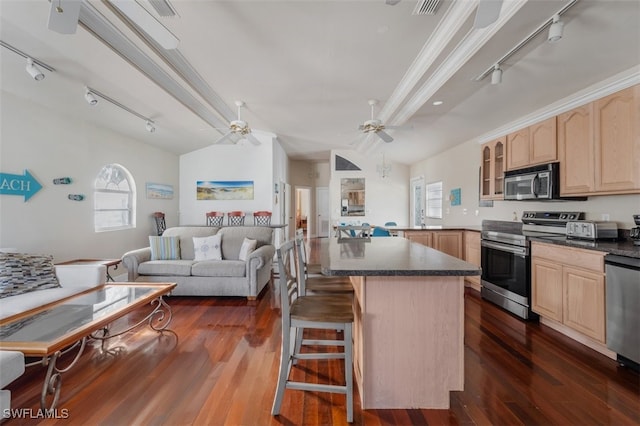 kitchen with a kitchen bar, appliances with stainless steel finishes, ornamental molding, dark wood-type flooring, and light brown cabinets