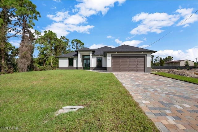 view of front of house featuring a front lawn and a garage