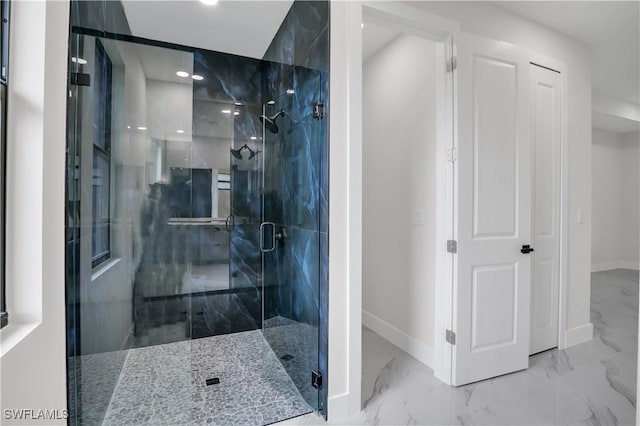 bathroom featuring a shower with door