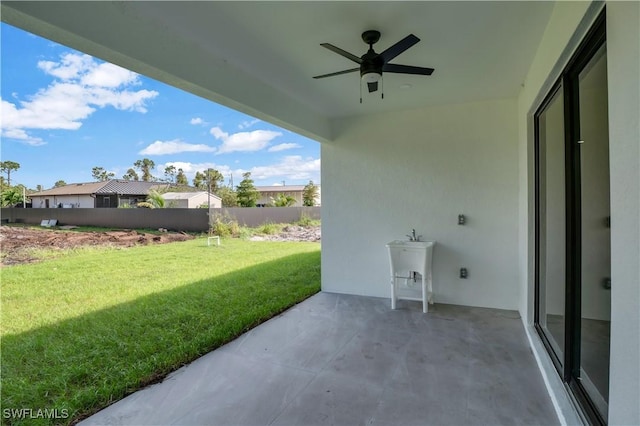 view of patio / terrace with ceiling fan and sink