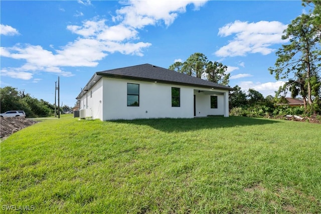 rear view of property featuring a lawn