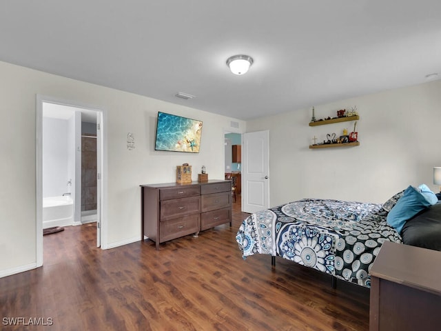 bedroom with connected bathroom and dark hardwood / wood-style floors