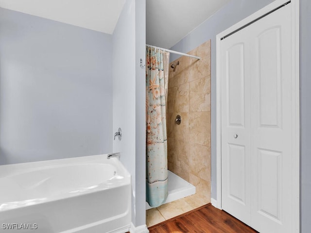 bathroom featuring hardwood / wood-style flooring and curtained shower