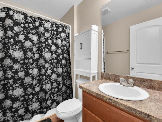 bathroom featuring hardwood / wood-style flooring, vanity, and toilet