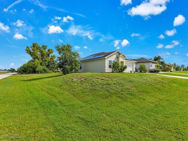 view of side of home featuring a lawn, a garage, and solar panels