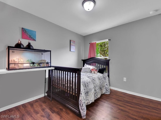 bedroom with dark wood-type flooring