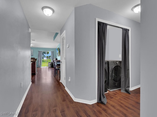 hallway with dark hardwood / wood-style flooring and separate washer and dryer