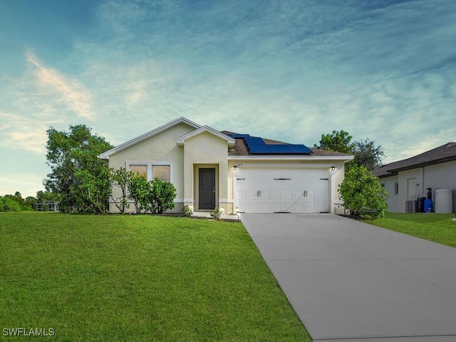 view of front of home with a front yard, solar panels, a garage, and central air condition unit