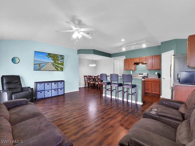 living room featuring ceiling fan with notable chandelier and dark hardwood / wood-style floors