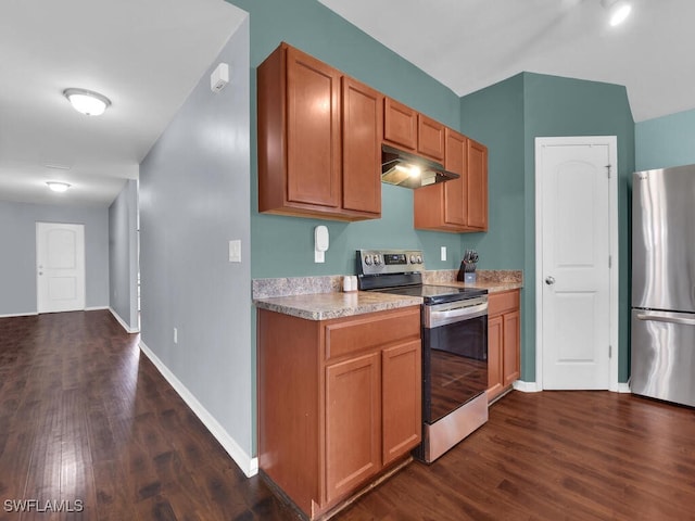 kitchen with stainless steel appliances and dark hardwood / wood-style floors