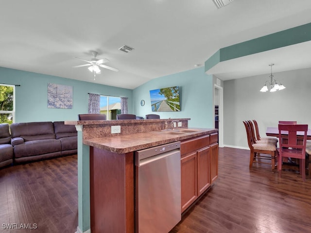 kitchen with a wealth of natural light, dishwasher, sink, pendant lighting, and a center island with sink