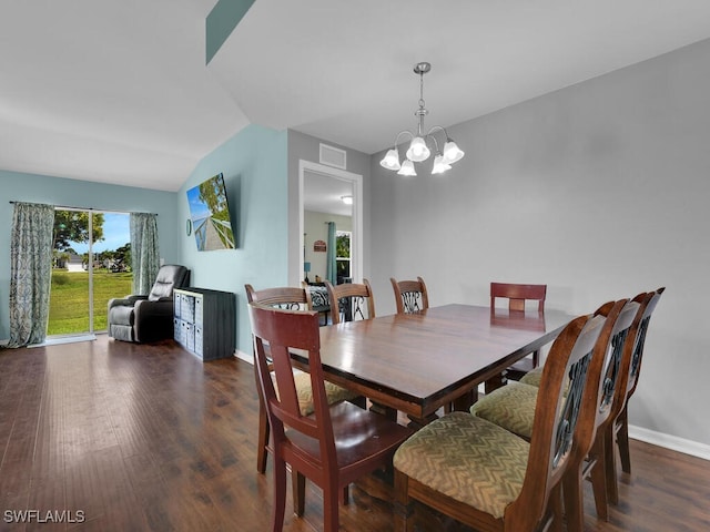 dining area featuring dark hardwood / wood-style flooring, a chandelier, and vaulted ceiling