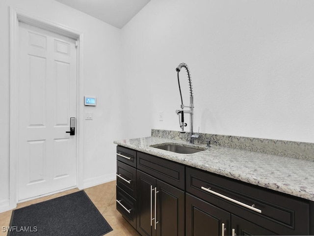 bathroom featuring tile patterned flooring, vanity, and baseboards