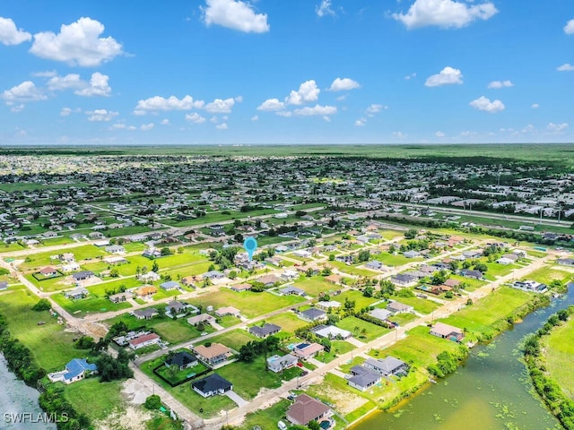 birds eye view of property featuring a water view and a residential view